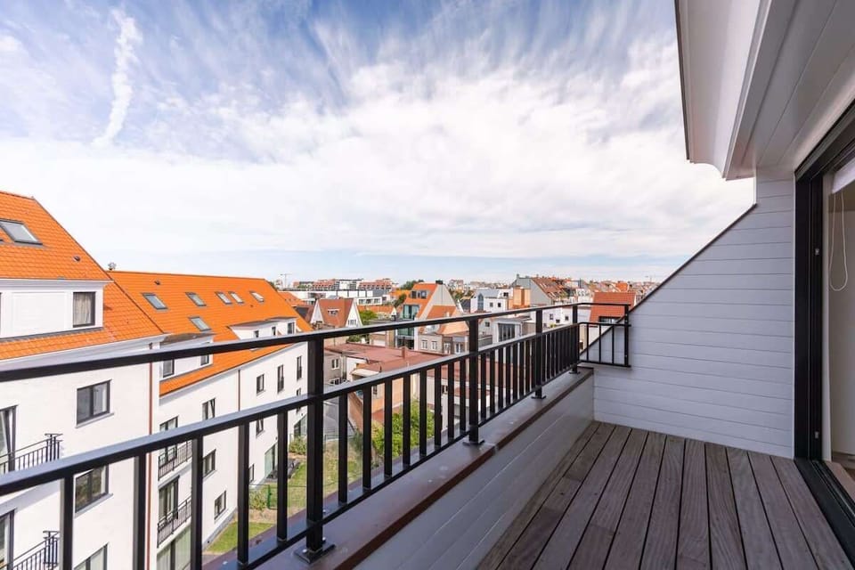Spacious balcony with city views and modern railing design.