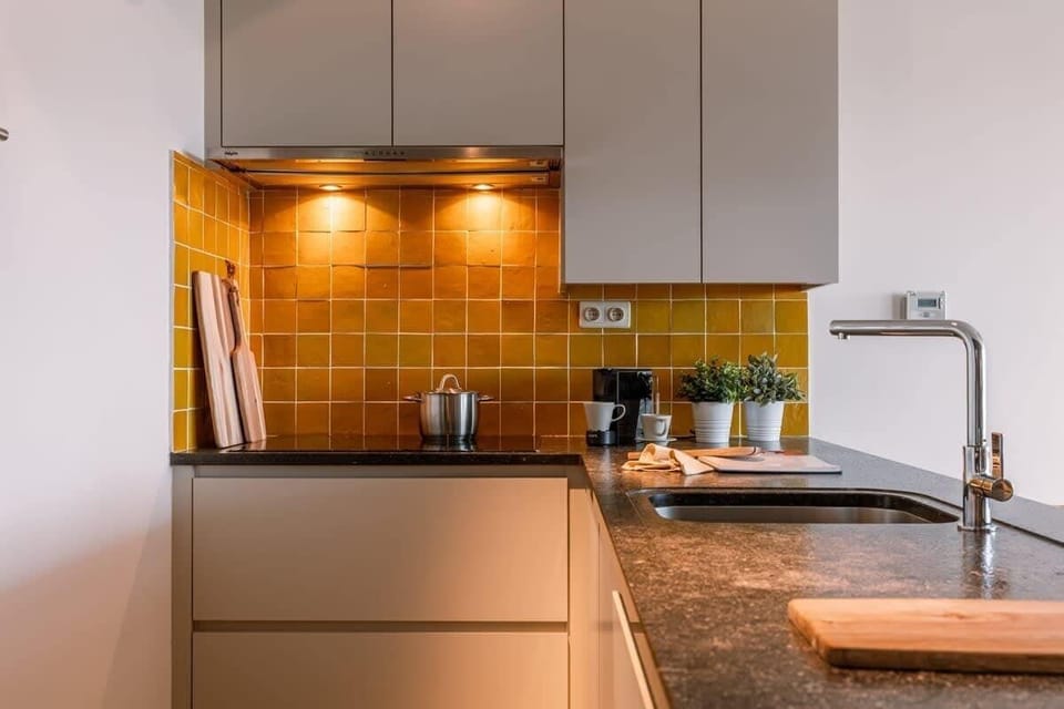 Warm kitchen with modern appliances.