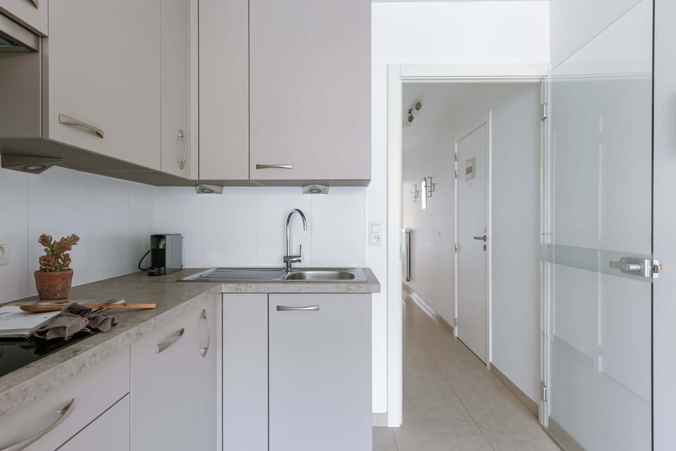 Modern kitchen with sleek cabinetry and a compact coffee machine for convenient mornings.