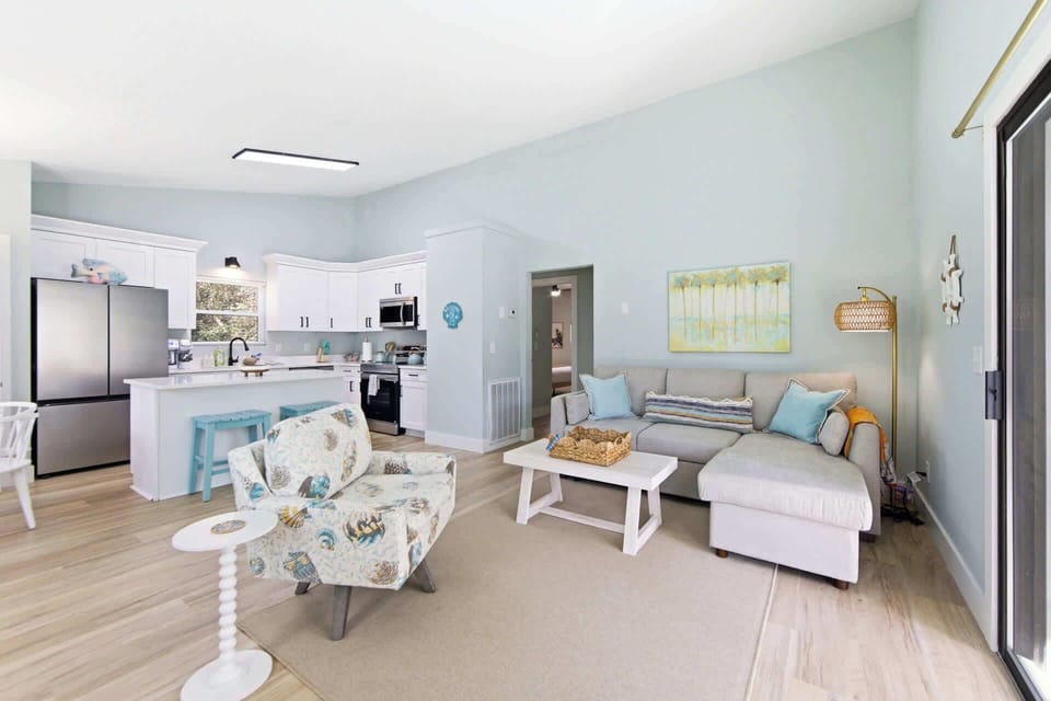 Light-filled living space with comfortable sofa, sliding doors, and easy access to outdoor deck