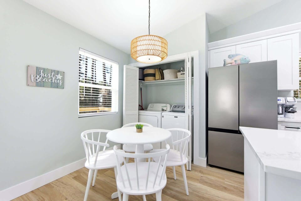 Light-filled dining space with contemporary design, open kitchen layout, and sleek finishes for comfortable vacation living