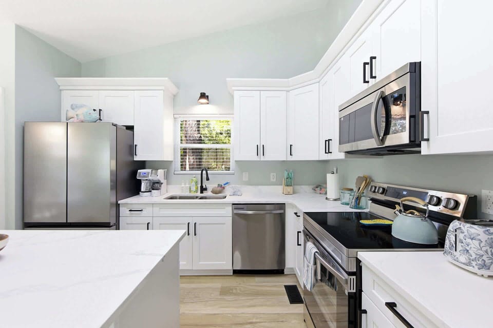 Fully equipped modern kitchen with quartz counters, natural light, and sleek finishes