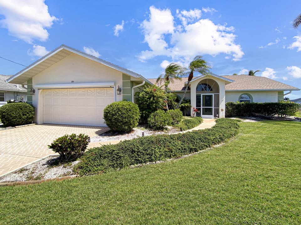 Charming home with lush landscaping and a welcoming entrance.