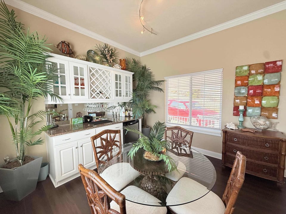 The dining area, seating 4, offers a dry bar with mini fridge – hello, cocktail hour!​
