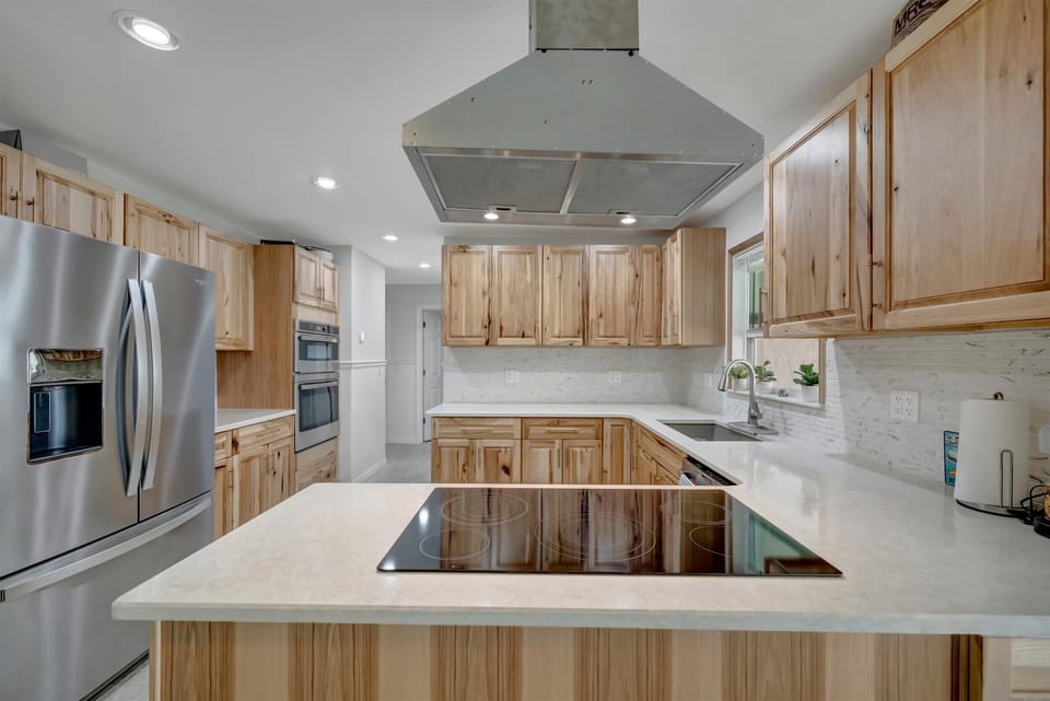Kitchen island with cooktop and prep space