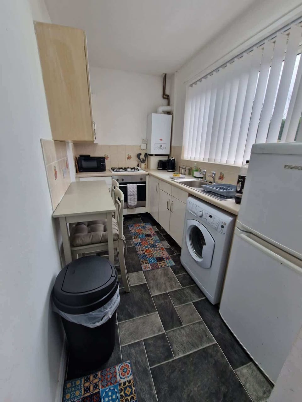 Kitchen, with oven, hob, microwave, washing machine and fridge freezer. Pans, baking trays, crockery and cutlery