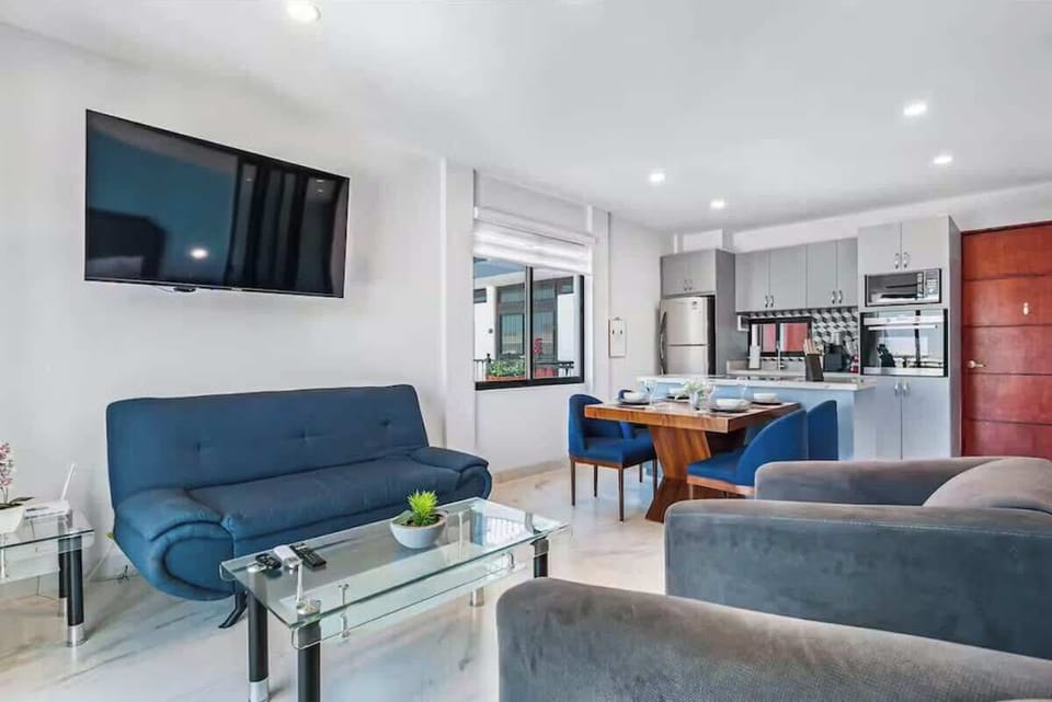 Relaxing living room w/ sofa, TV & open-plan layout