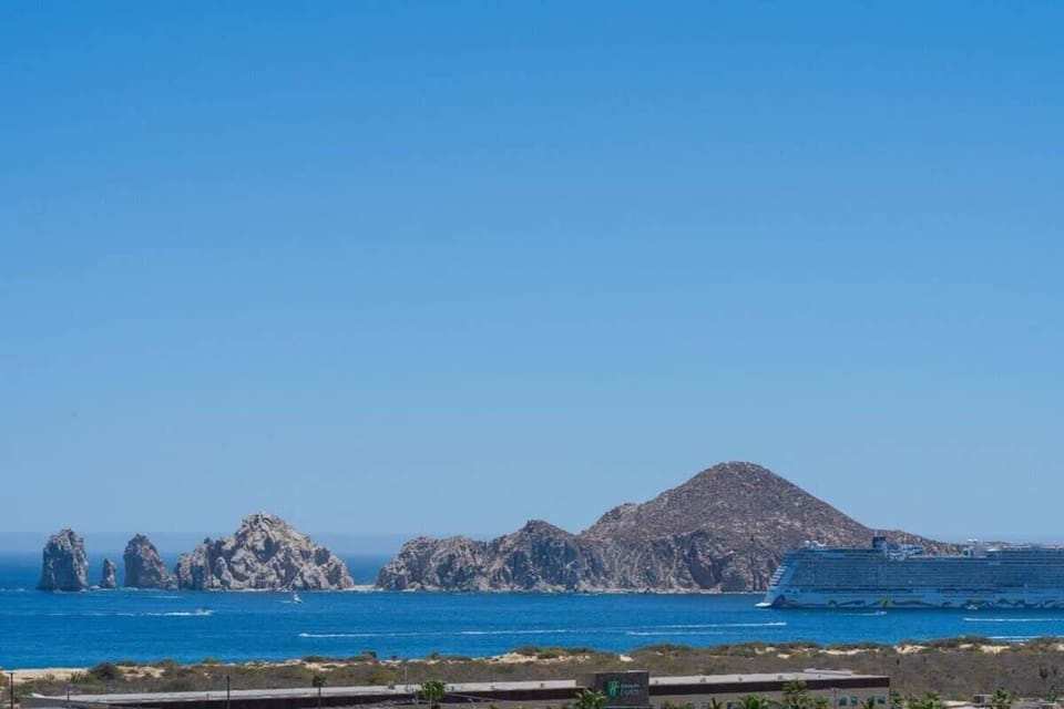 Scenic coastal view w/ calm waters & distant mountains