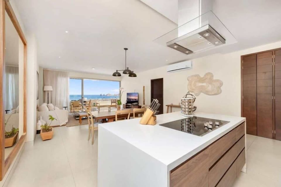 Sleek kitchen w/ island seating, modern finishes & open layout
