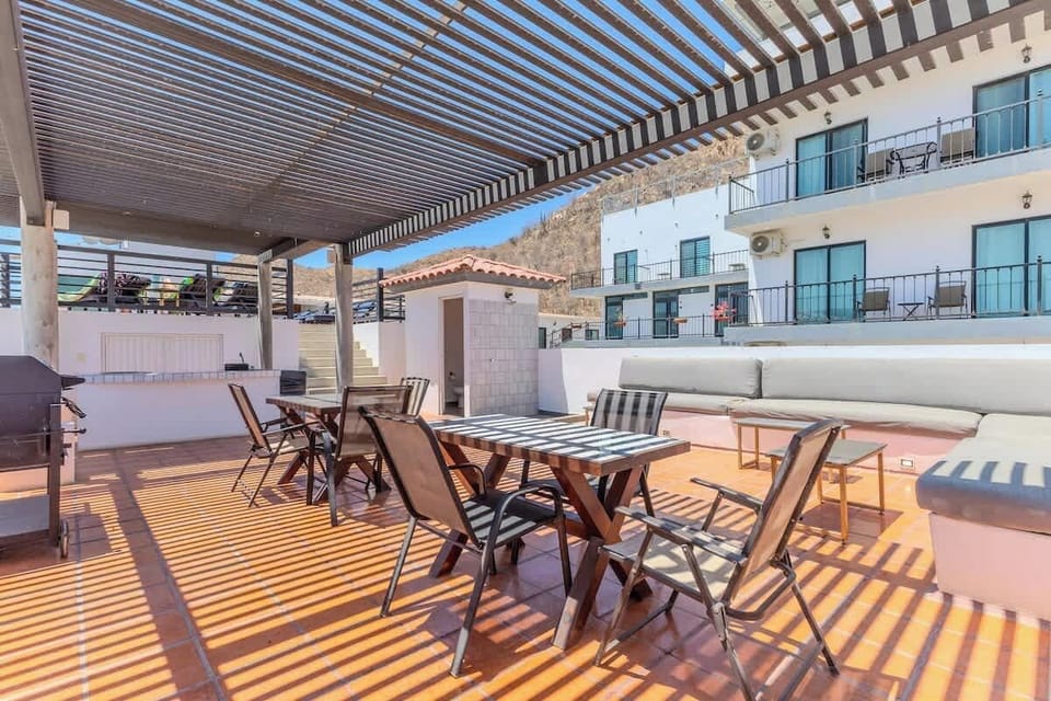 Shared terrace w/ dining table & pergola, ideal for shaded outdoor meals