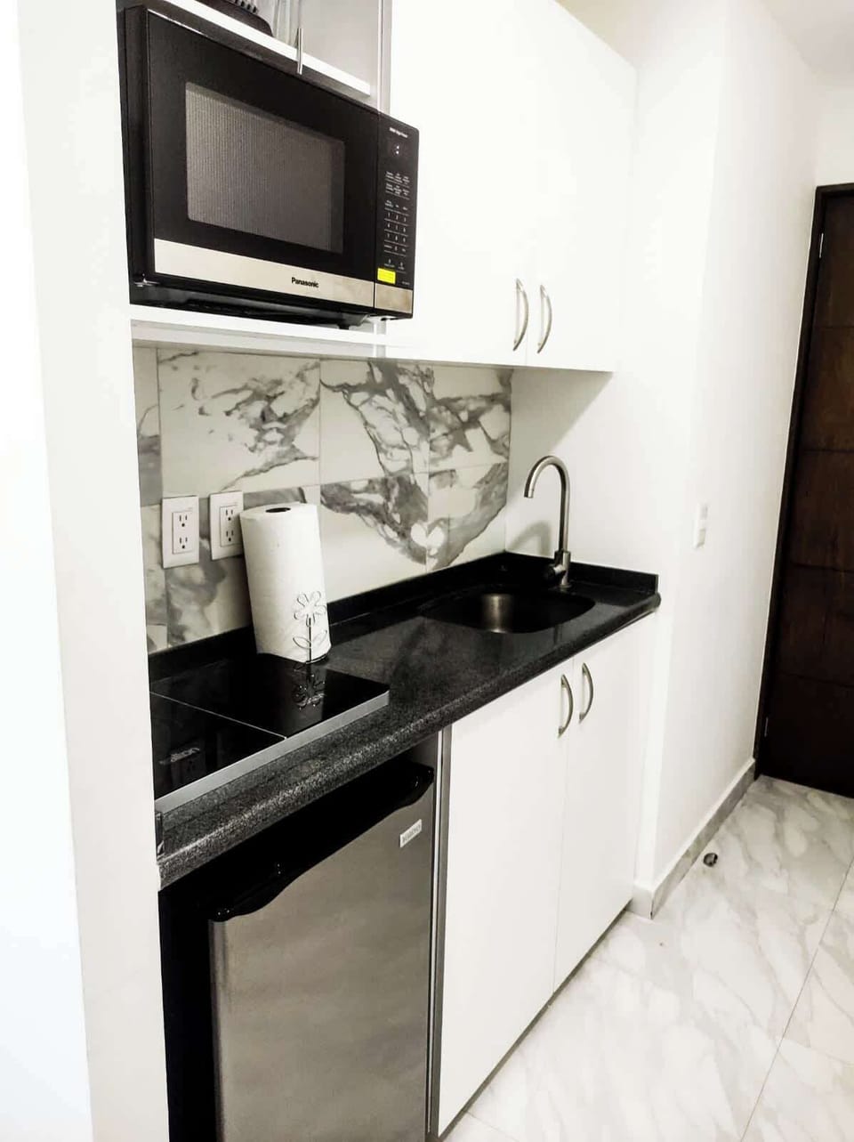 Compact kitchenette w/ sleek counters & essentials for easy meal prep