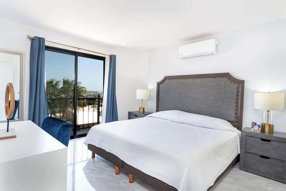 Cozy bedroom w/ plush bed, soft tones & natural light for restful nights