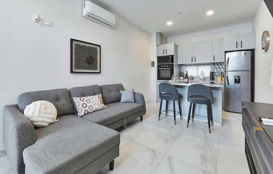 Bright living room w/ comfy sofa, TV & natural light for relaxed downtime