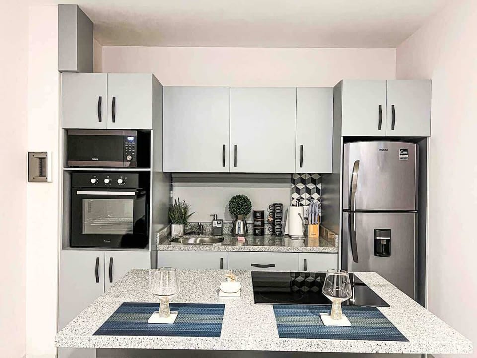 Modern kitchen w/ clean lines, ample storage & prep space