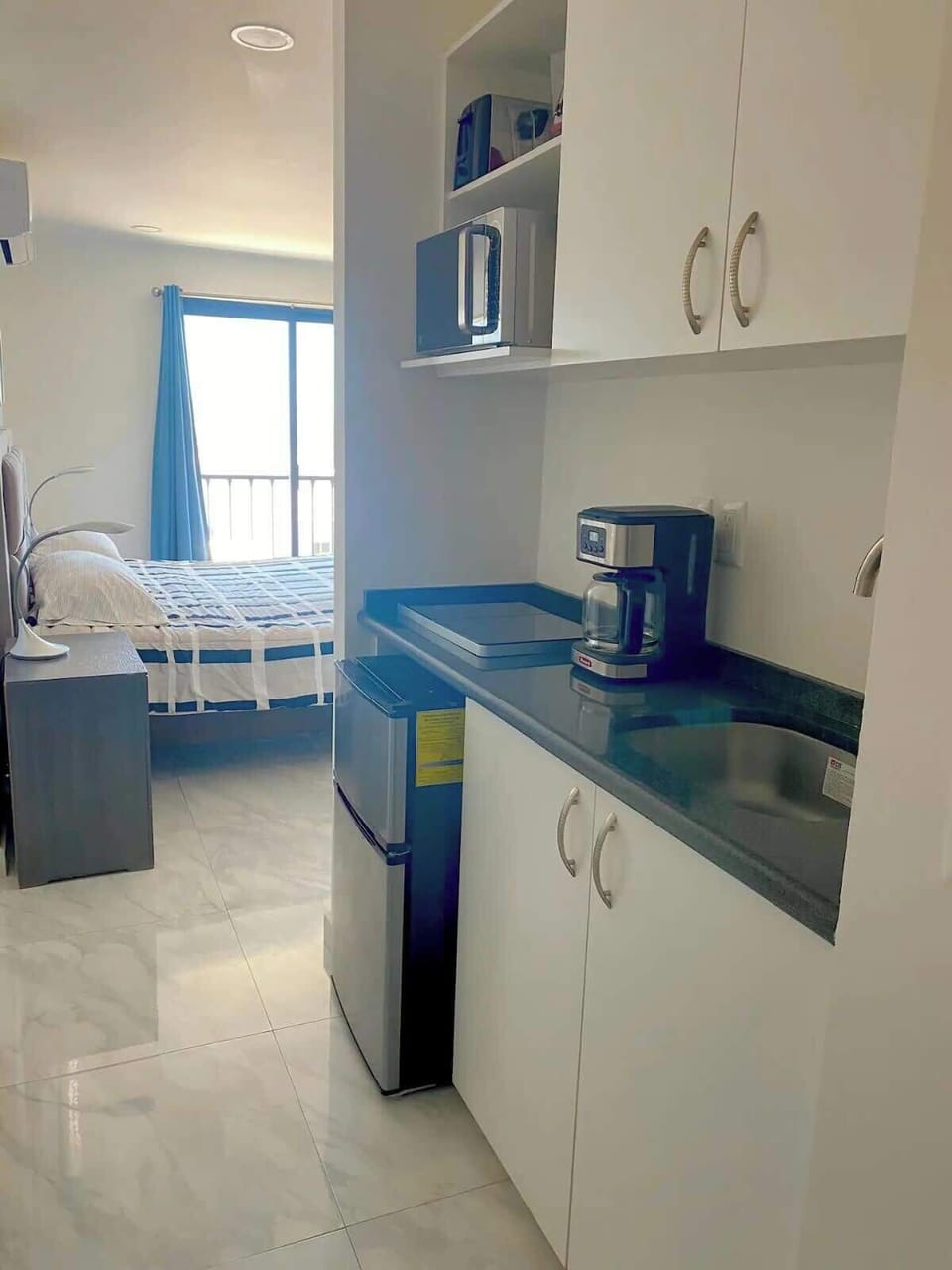 Compact kitchen w/ sleek counters & essentials for easy meal prep