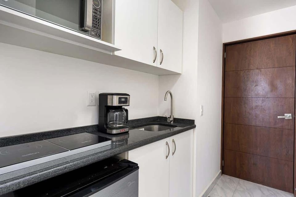 Compact kitchen w/ sleek counters & essentials for easy meal prep