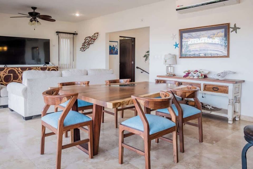 Dining area w/ wood table & bright, airy feel