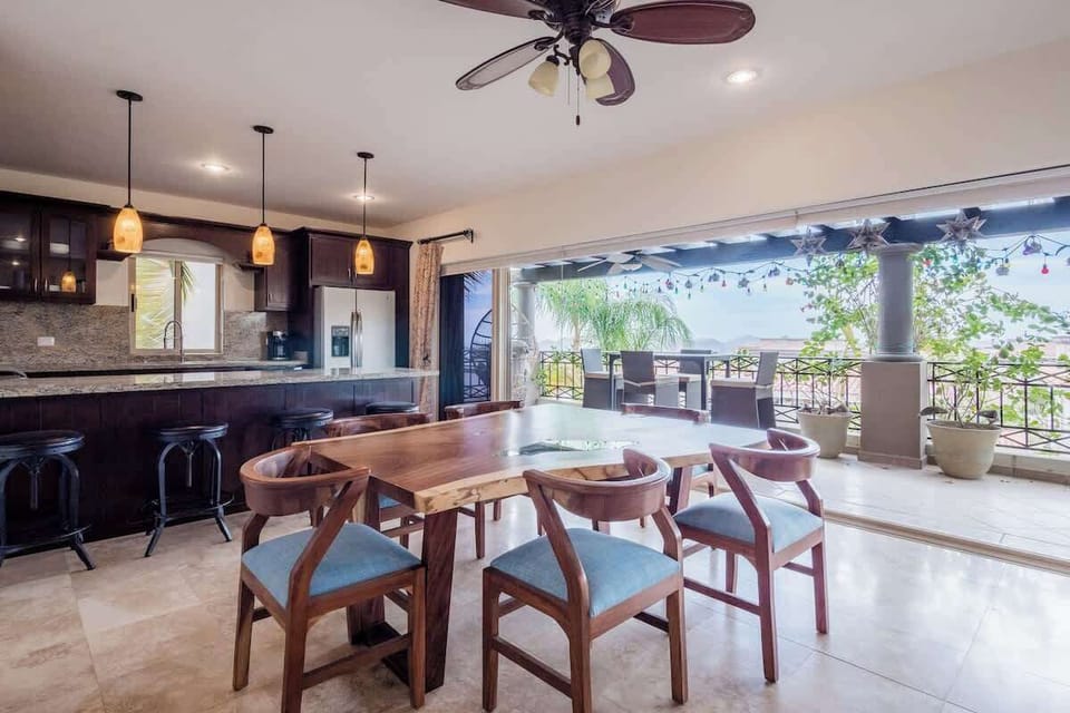 Open dining area flowing into kitchen, ideal for shared meals & conversation