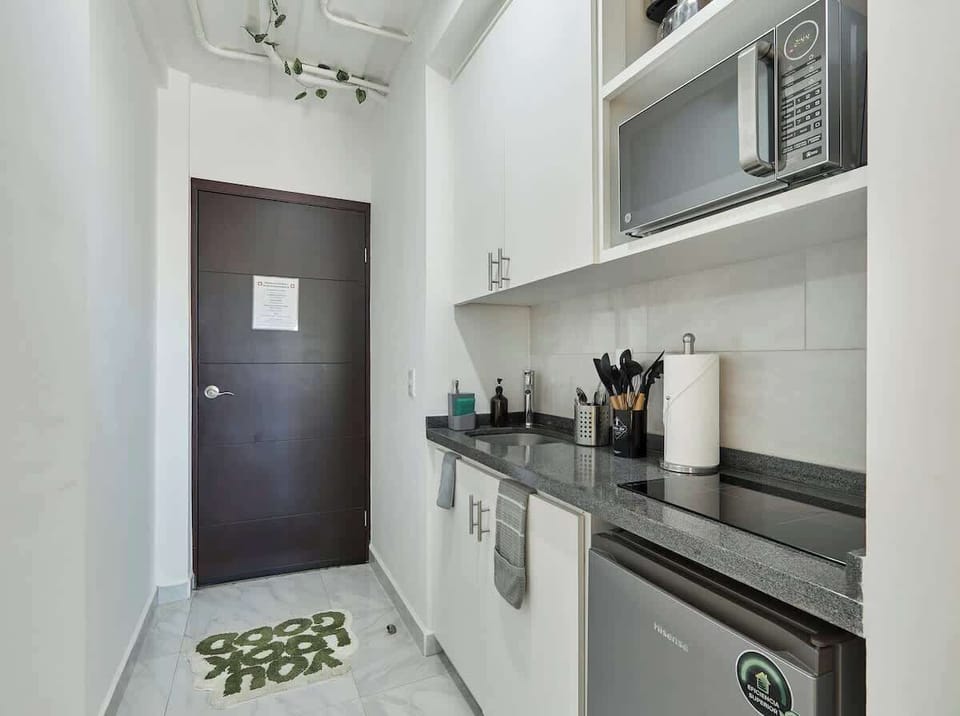 Sleek kitchenette w/ microwave, sink, and essentials for easy meal prep