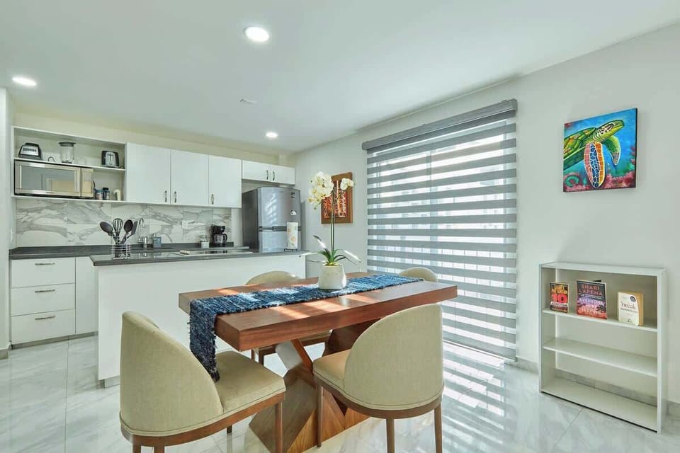 Dining area w/ sleek table set near the kitchen for easy, relaxed meals