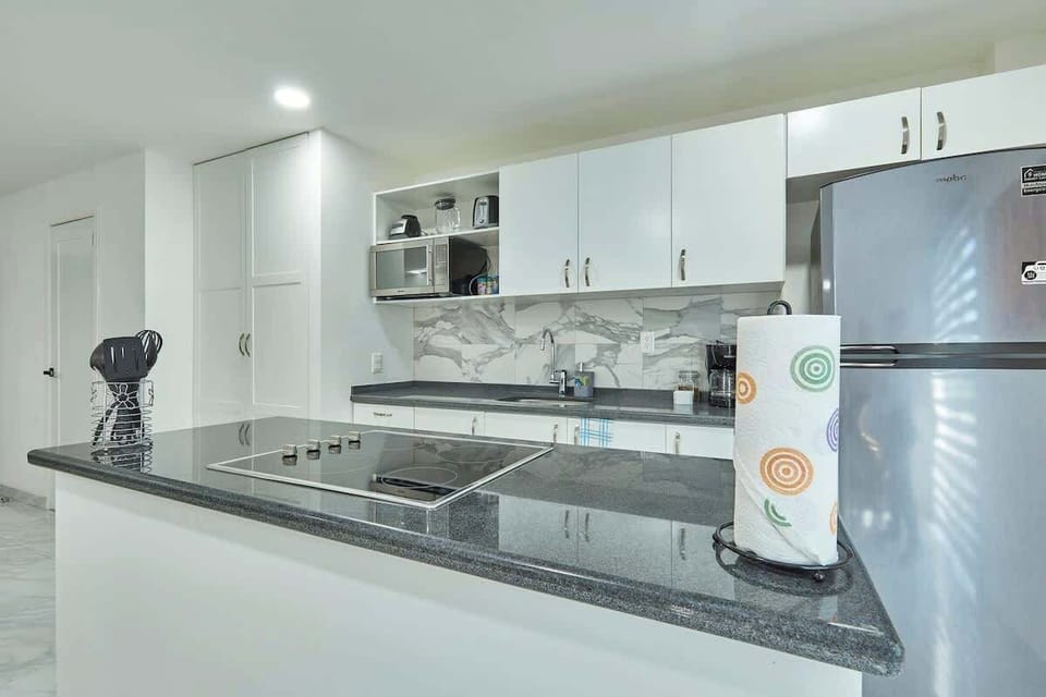 Modern kitchen w/ stainless appliances & clean, streamlined counters