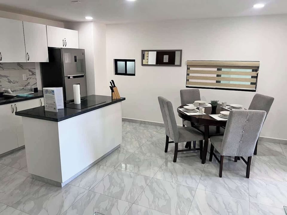 Open dining area w/ set table & kitchen just steps away