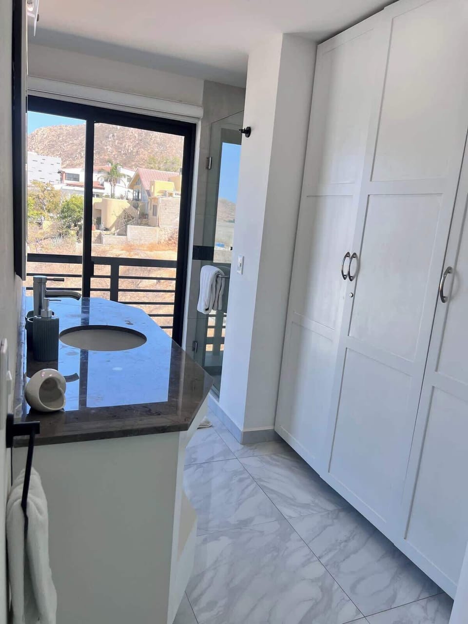 Spacious bathroom layout w/ built-in closets & balcony access