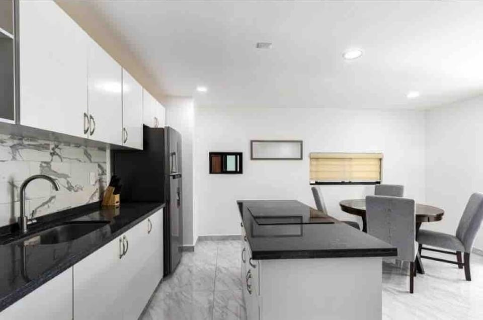 Open kitchen & dining area w/ island seating & a relaxed layout