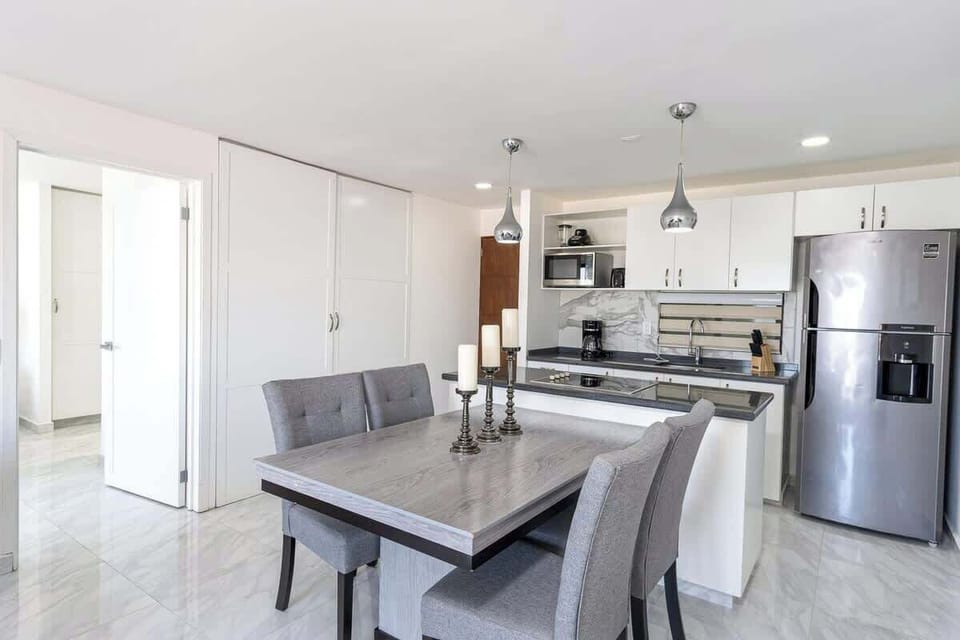 Open dining area w/ table for shared meals, seamlessly connected to the kitchen