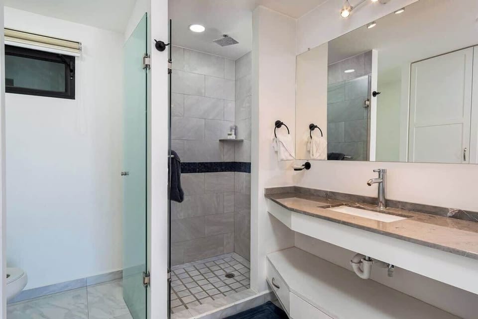 Bathroom w/ walk-in shower, sink & bright, clean design