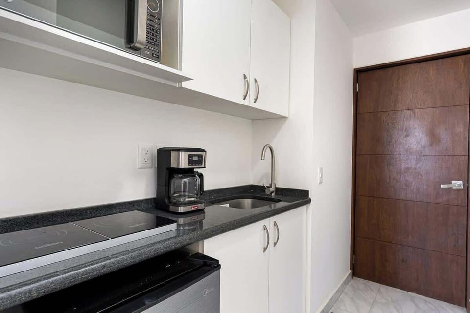Compact kitchen w/ sleek counters, storage & essentials for easy meal prep