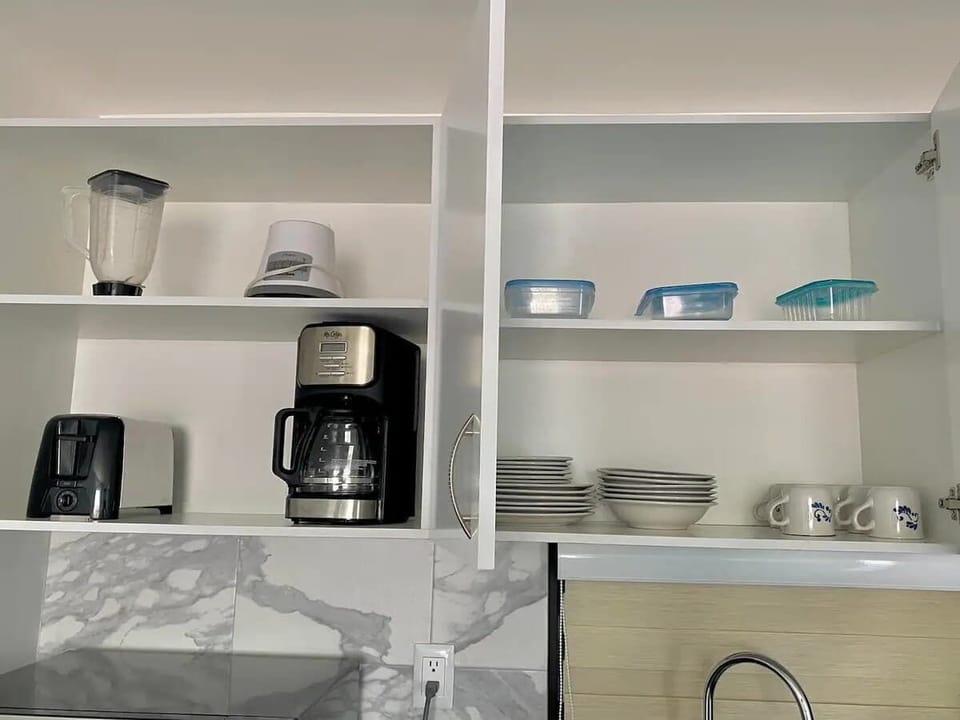 Kitchen shelves w/ coffee maker, dishes & organized storage for daily use