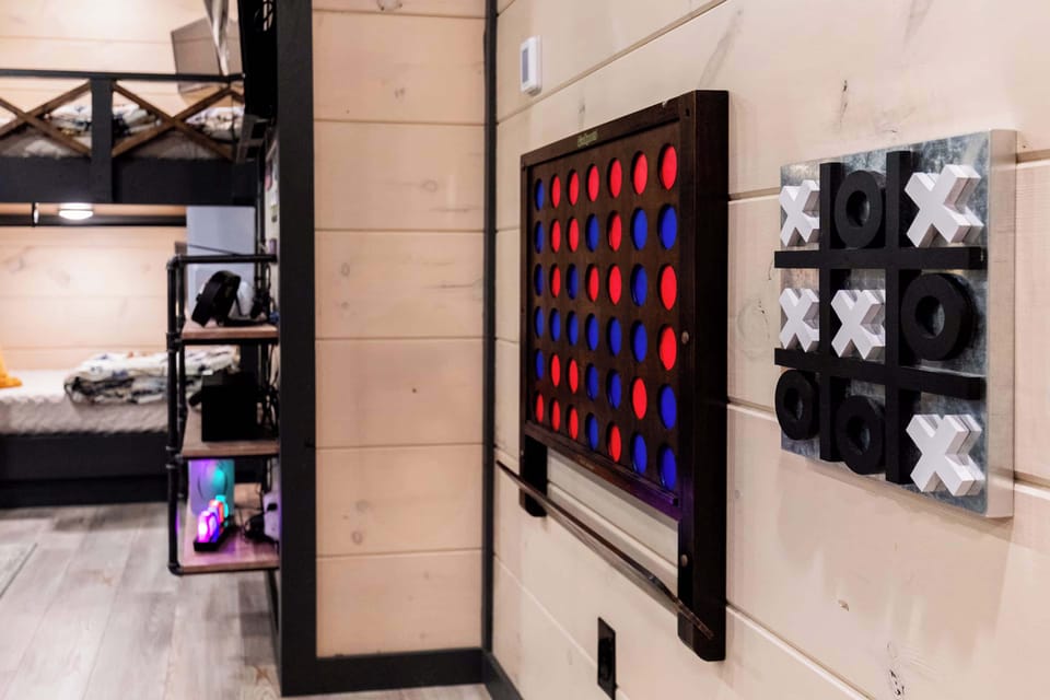 Hallway game area w/ oversized wall games & playful touches throughout the home