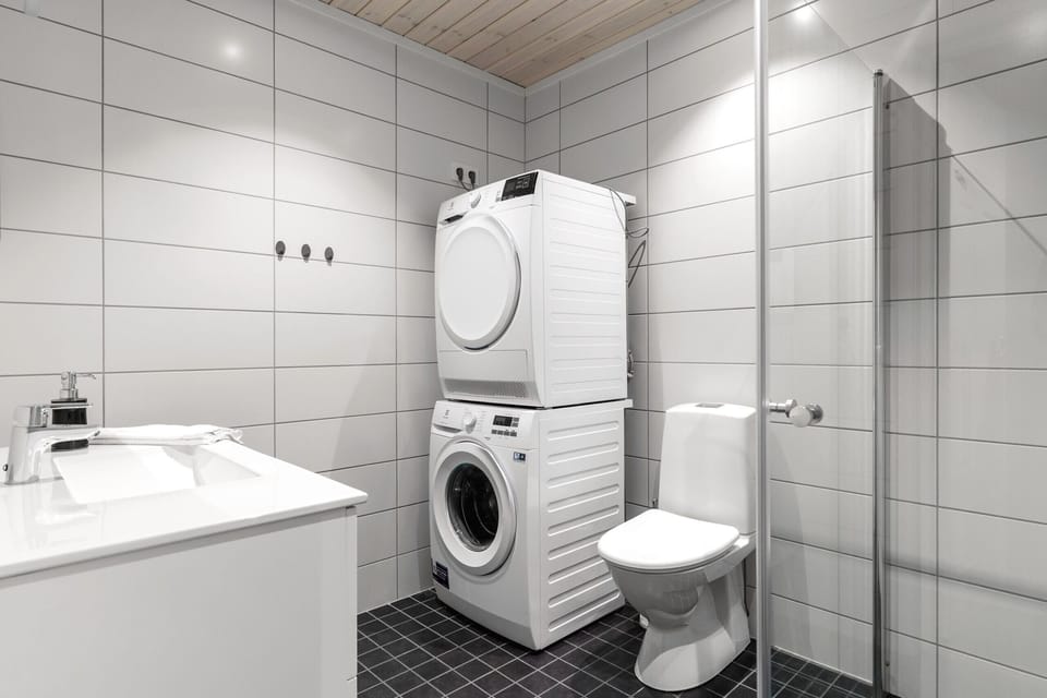 Modern bathroom with washing machine and dryer