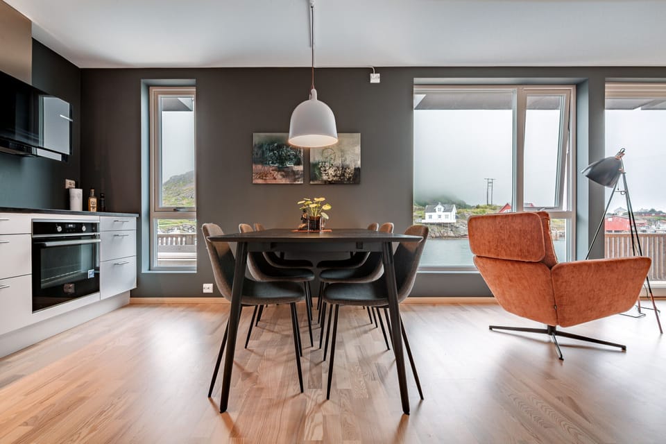 The apartment has large windows and is located on the docks by the sea
