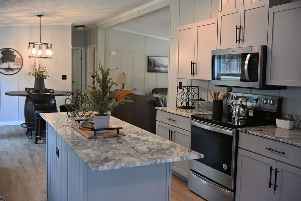 The kitchen features new appliances, a center island, and is fully stocked for all your cooking needs.