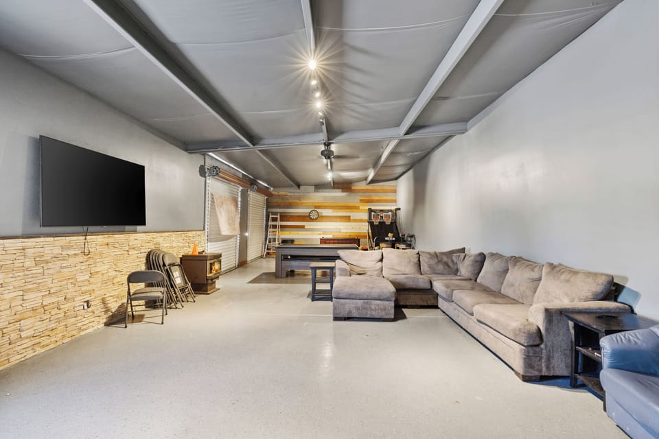 Relax and unwind in the Zebra Ranch rec room-your cozy hangout space with comfy seating, a TV, and plenty of room to kick back after a day on the ranch.