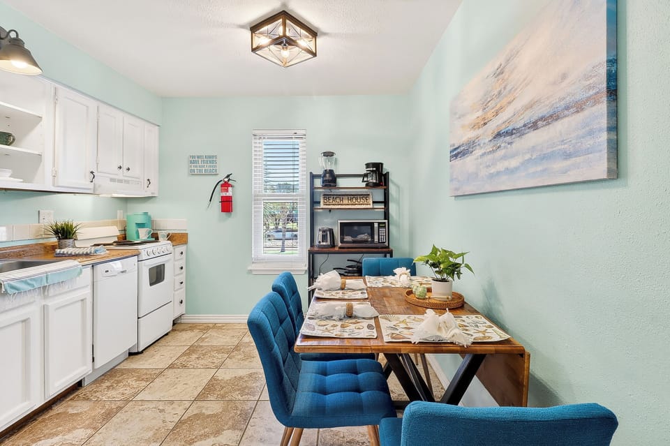 Your fully equipped kitchen flows seamlessly into a bright dining area where morning coffee and family meals become cherished vacation memories.