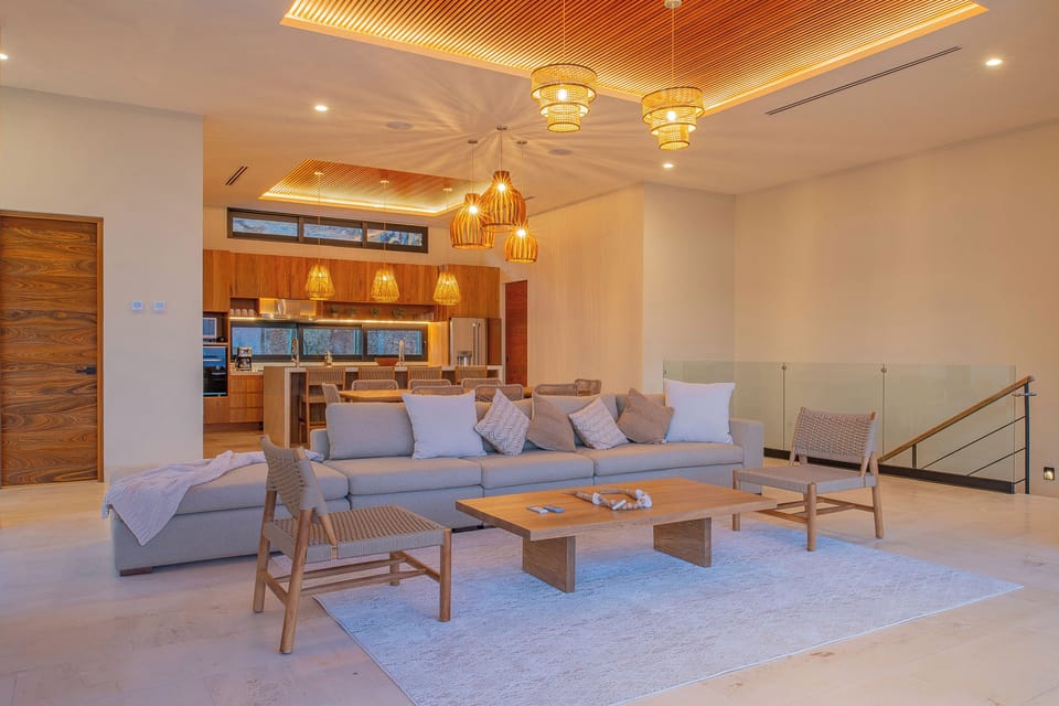 Unwind in your stunning open-plan living space, where warm wood accents and contemporary design create the perfect atmosphere for relaxation.