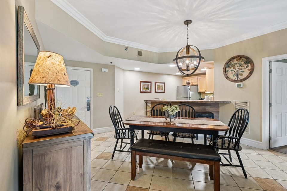 Gather around your welcoming dining table, where warm lighting and thoughtful touches create the perfect setting for memorable meals together.