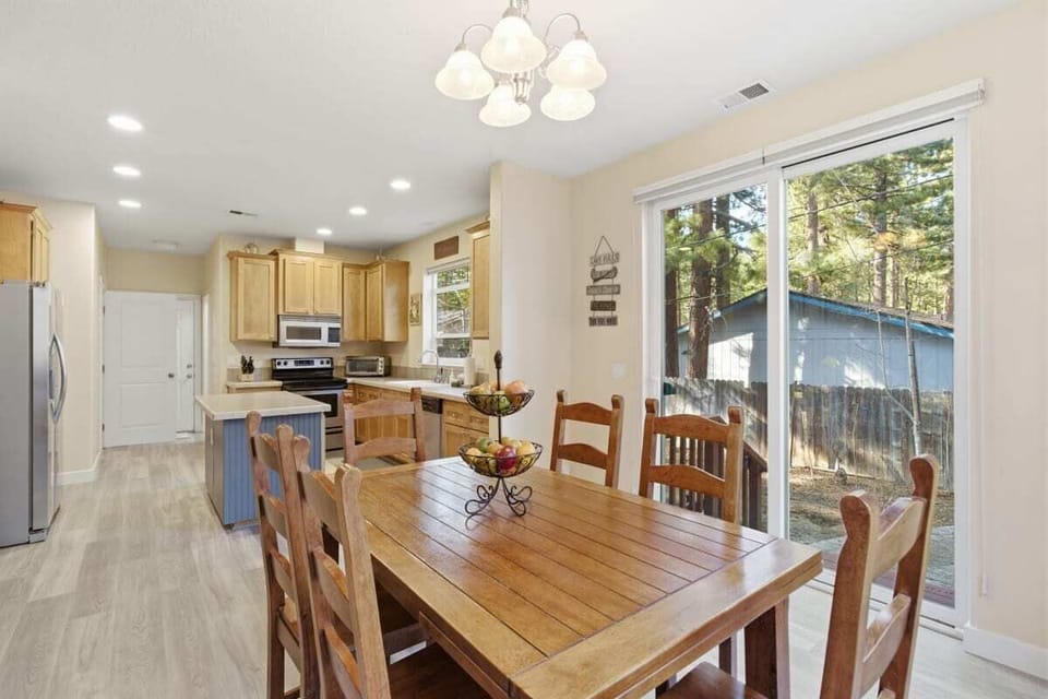 Bright dining area with a rustic table and modern chairs.