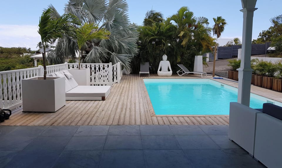 Bright interior lounge with sea view, designed to blend contemporary aesthetics with Caribbean laid-back living.