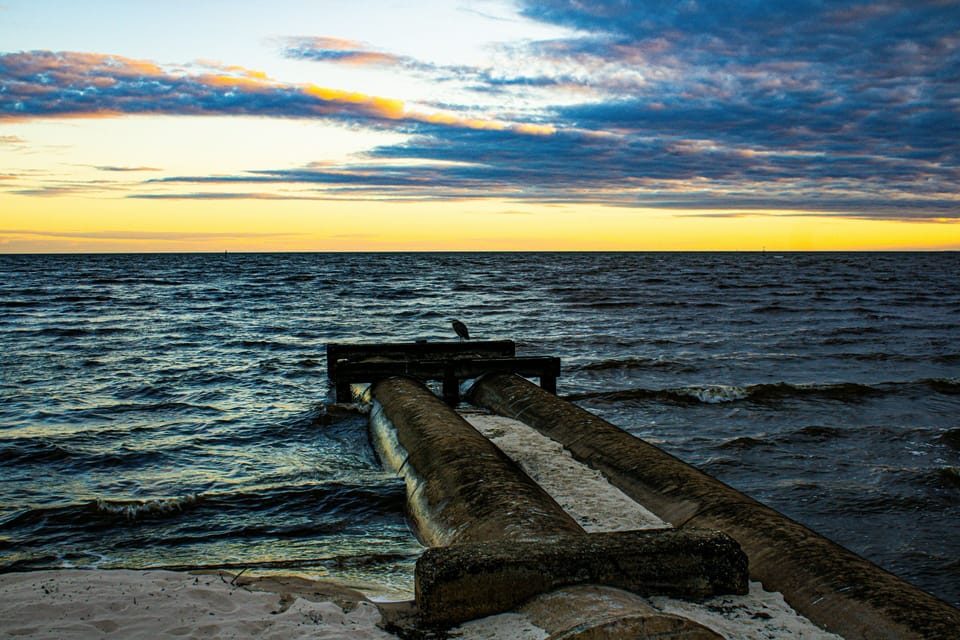 Step outside to Mississippi Sound views — golden-hour light over the water
