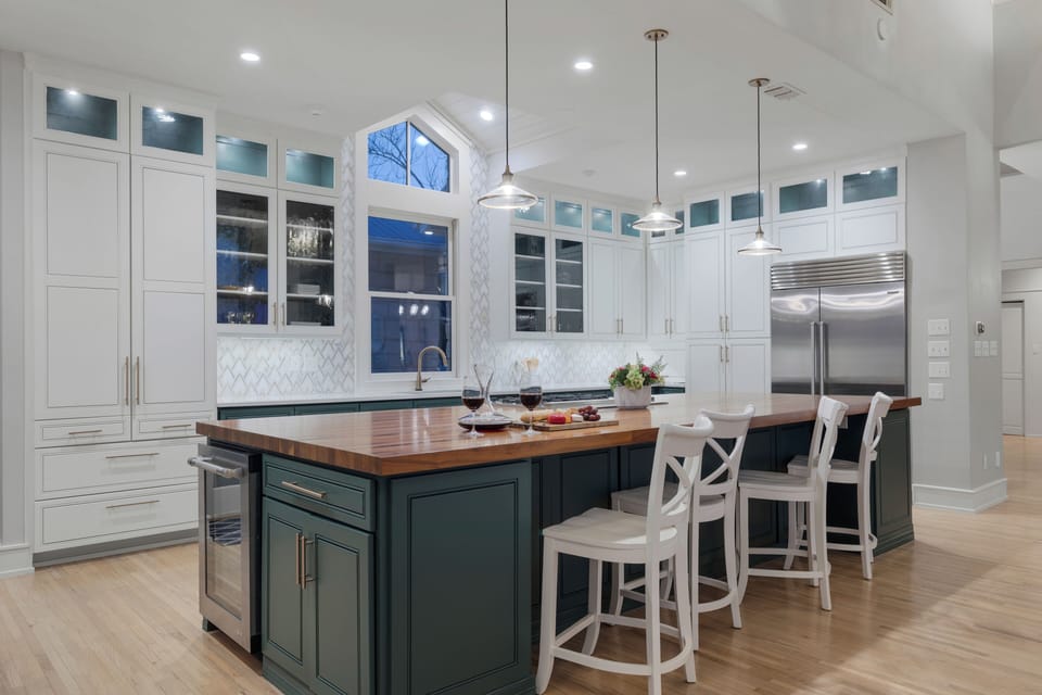 Island bar — butcher block, four seats, Sub-Zero  refrigerator.