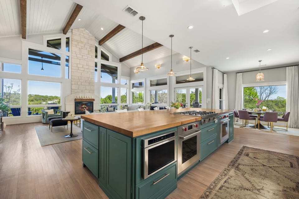 Chef's kitchen — pro range, butcher block, cathedral ceiling.