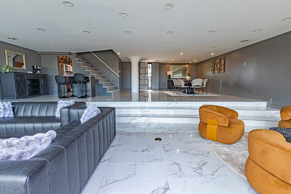 Bright, open-plan living area with floor-to-ceiling windows and seamless access to the private patio—perfect for relaxing with skyline views.