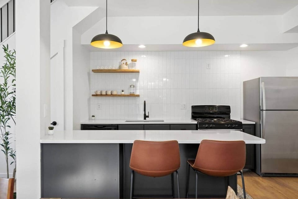 Stylish kitchen island with bar seating and warm pendant lighting—perfect for morning coffee, casual meals, or gathering while you cook.
