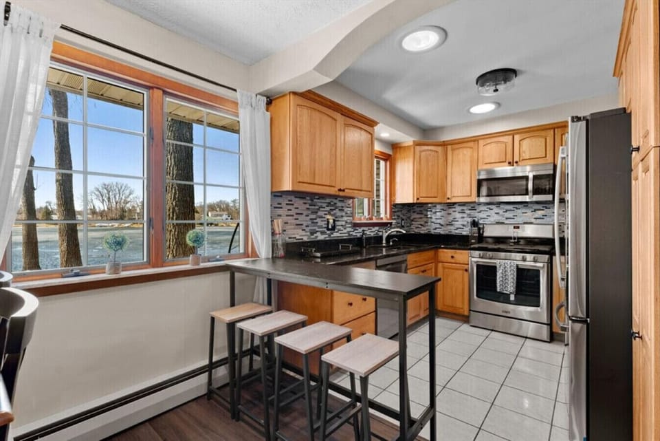 A bright kitchen corner with a window seat view of the water.