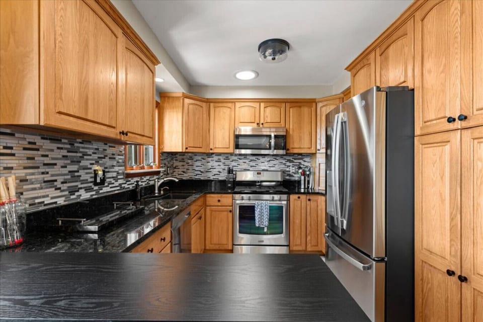 A well laid out kitchen with plenty of counter space and stainless appliances.