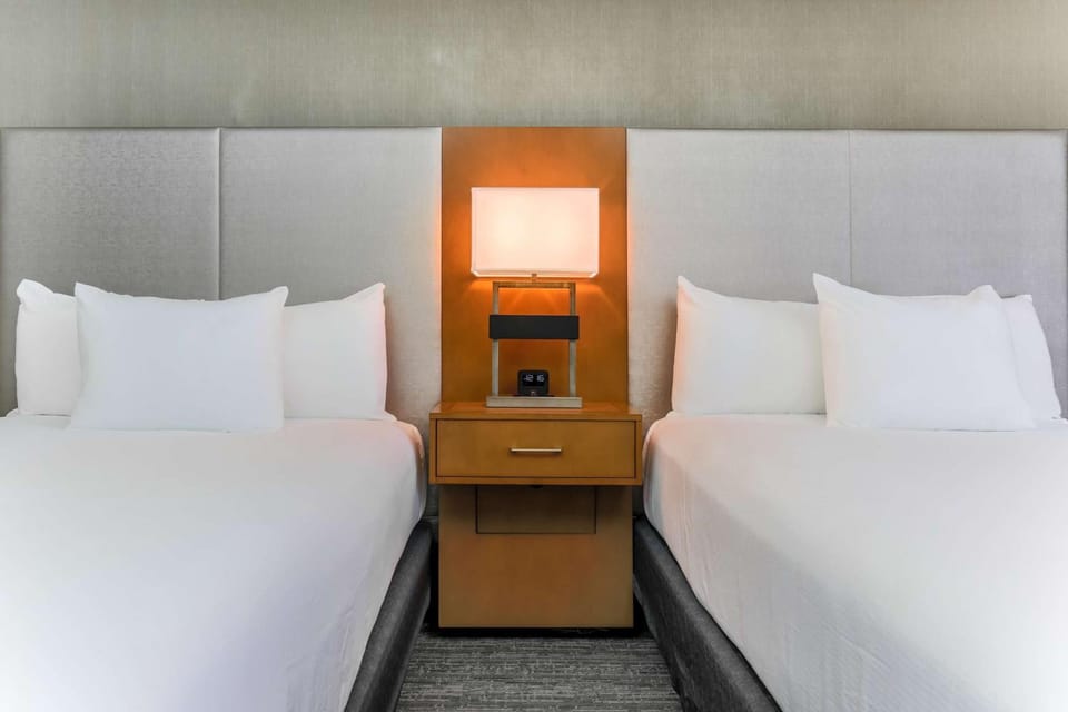 Drift off between plush pillows and warm bedside lighting.
